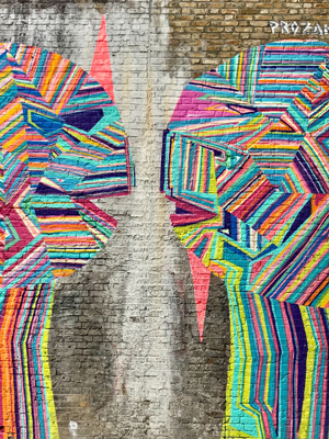 two multi-coloured heads on a wall