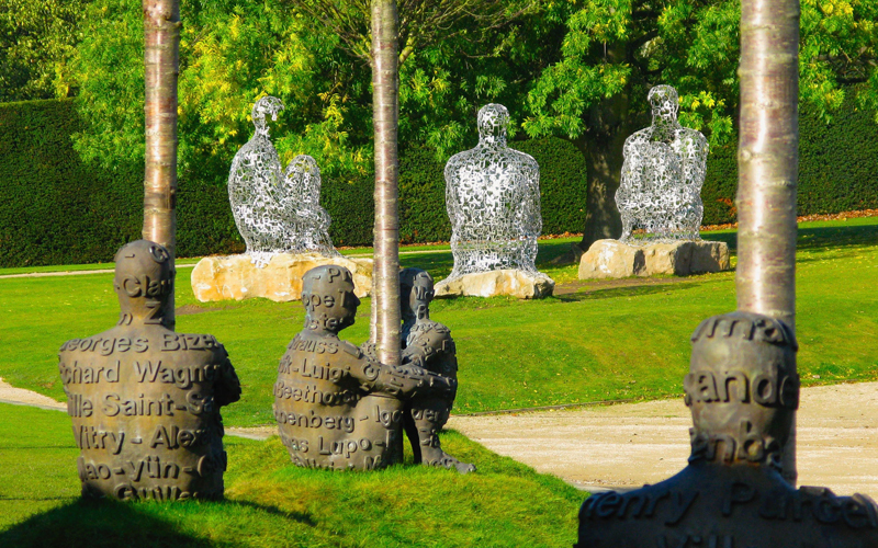 Sculptured figures sitting on grass